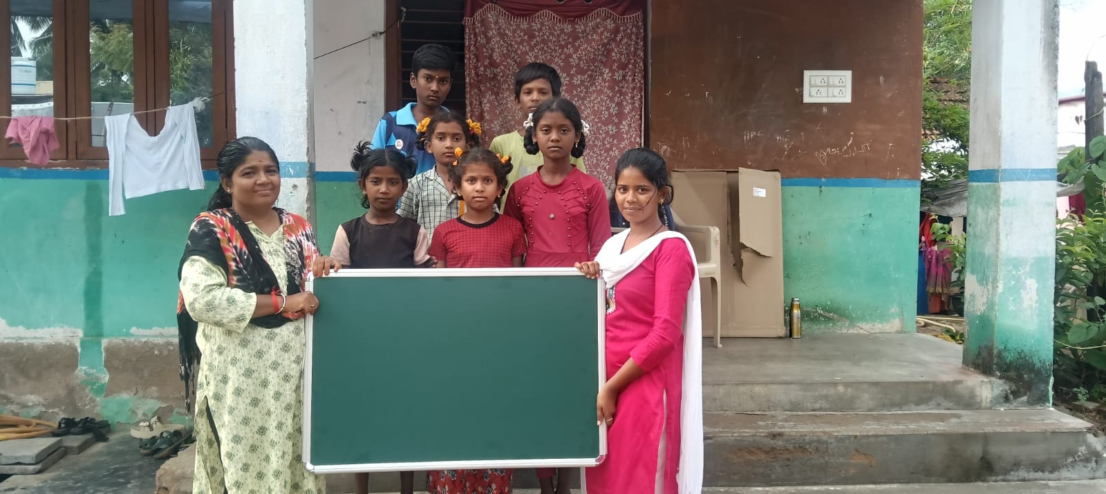 Teachers and students with one of the 22 blackboards delivered by The Jayavel Impex